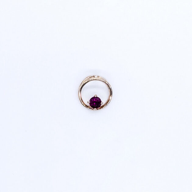 Small golden pendant with ruby